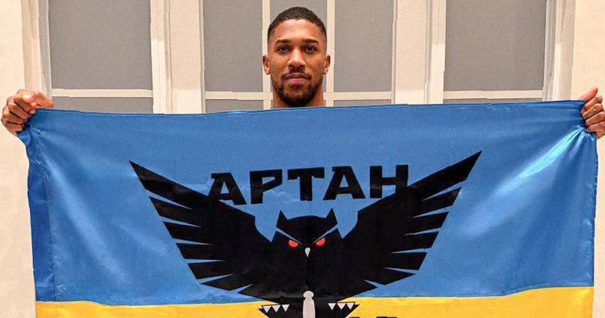Joshua Posed with a Ukrainian Flag Featuring the GUR Military Unit Logo